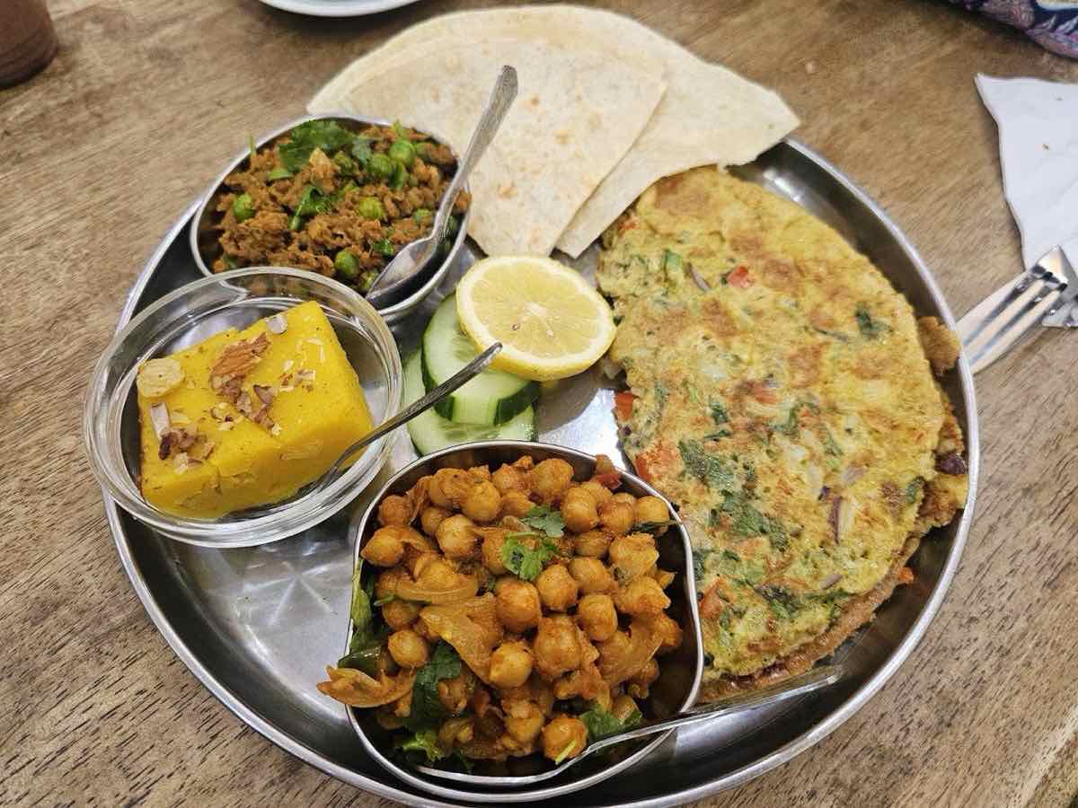 Desi breakfast platter at Delizia: masala omelette, keema with peas, chana masala, chapati, dhokla and salad